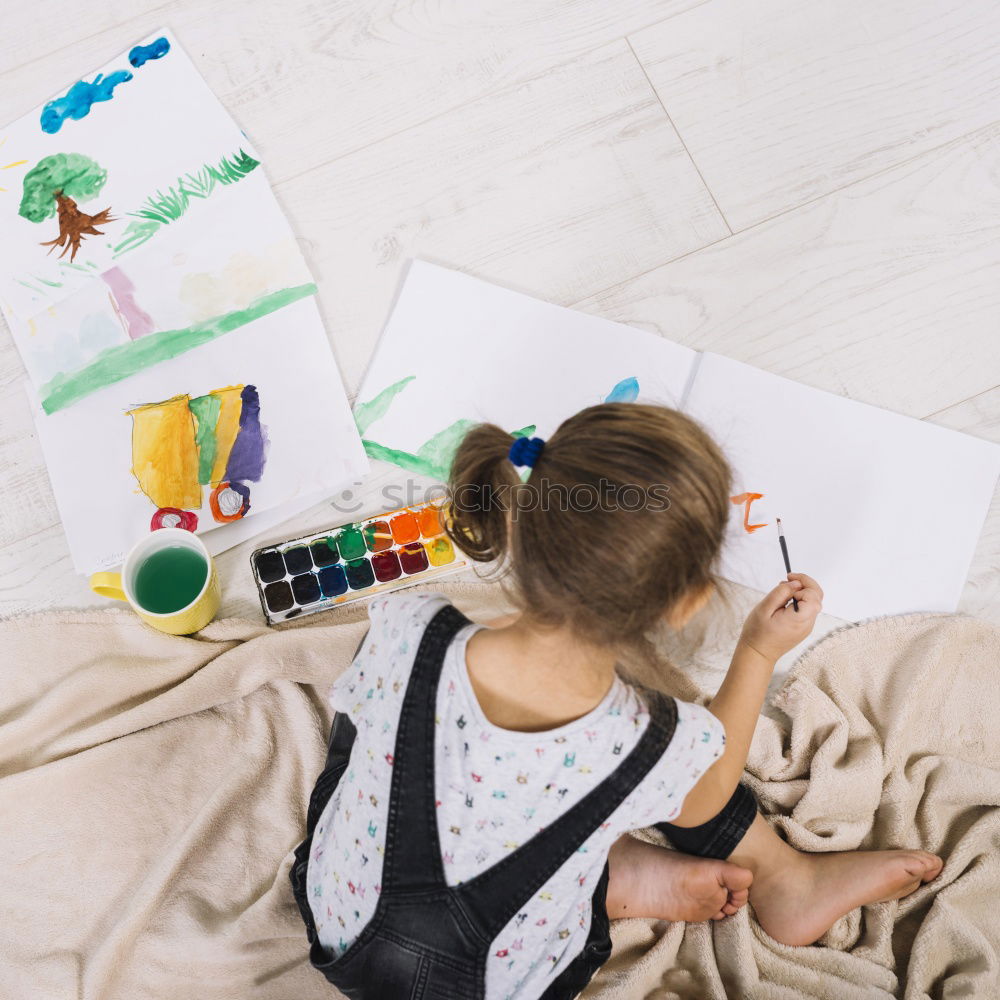 Similar – Image, Stock Photo Little girl doing homework on bed at home