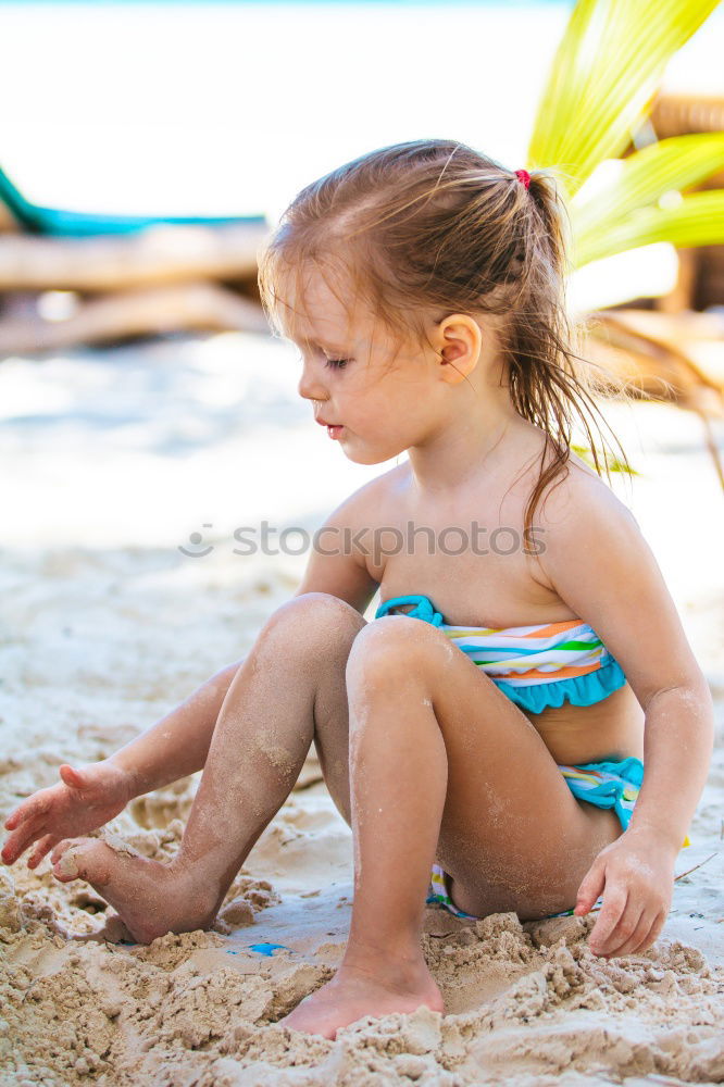 Two happy children playing on the beach