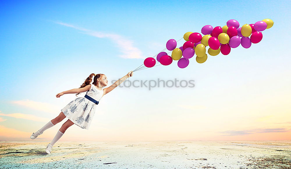 Similar – Father and daughter with balloons playing on the beach