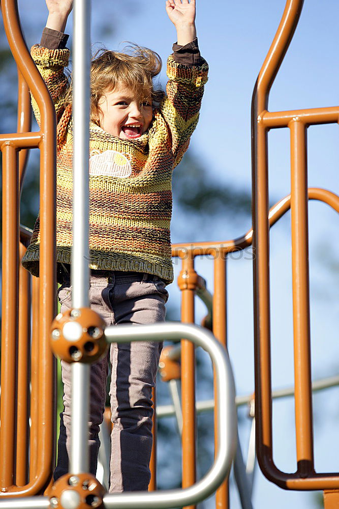 Similar – Child climbing on the playground in autumn