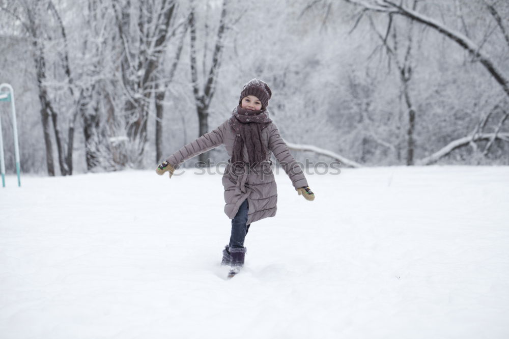 Similar – A woman pulls a sled through the snow. Winter atmosphere.