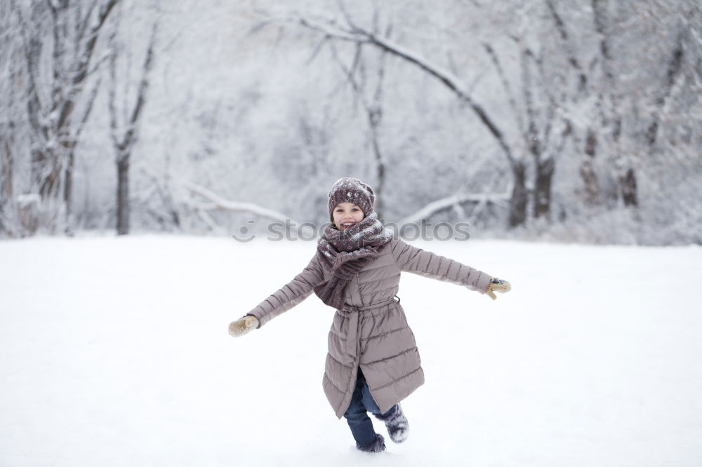 A woman pulls a sled through the snow. Winter atmosphere.