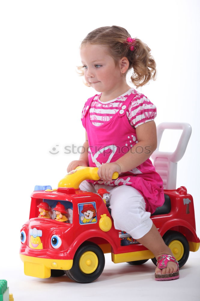 Similar – Young girl playing to driving a toy car