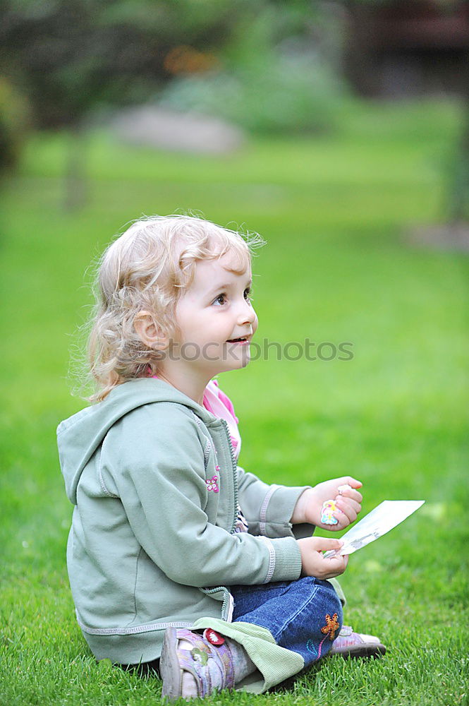 Image, Stock Photo Little baby girl watching a book with pictures