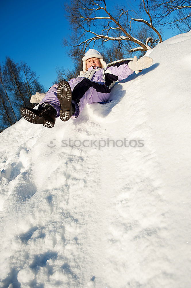 Similar – Image, Stock Photo Young cute woman lying playing and enjoying snow in winter