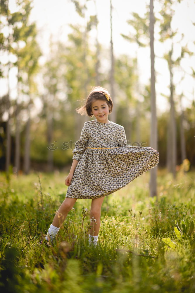 Similar – Kleines Mädchen im Naturfeld mit schönem Kleid