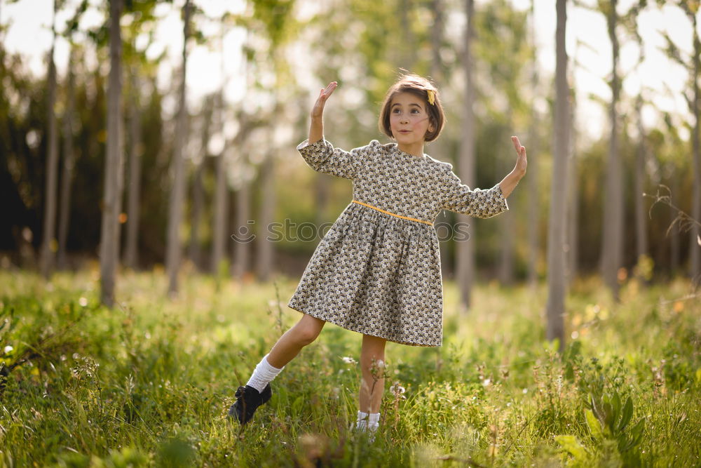 Similar – Kleines Mädchen im Naturfeld mit schönem Kleid