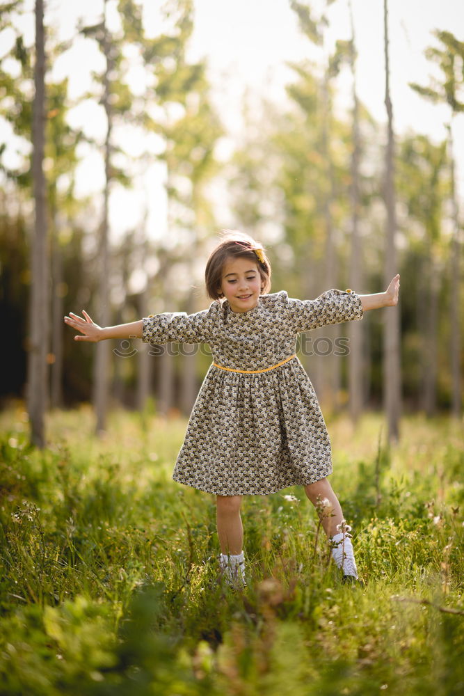 Similar – Kleines Mädchen im Naturfeld mit schönem Kleid