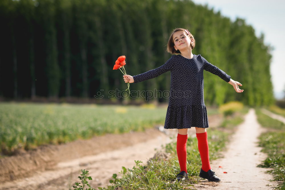 Similar – Image, Stock Photo Little girl in poppies field wearing beautiful dress