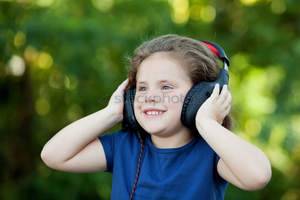 Image, Stock Photo Little girl with headphones outside