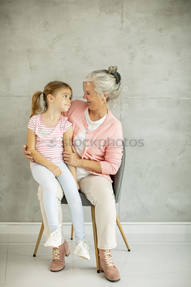 Similar – Baby girl holding finger of senior man hand