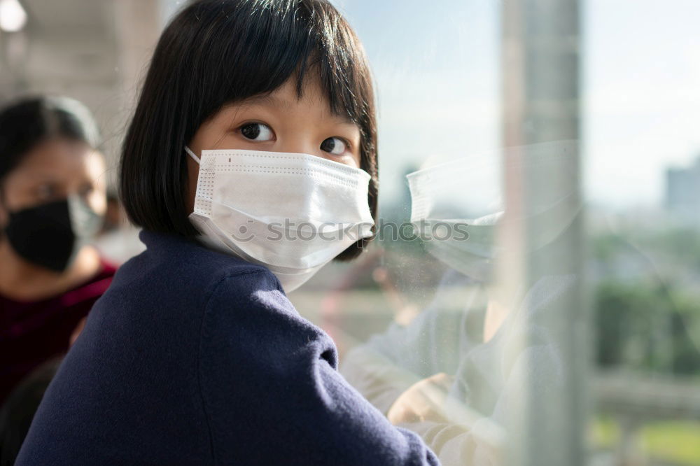 Similar – young woman wearing a mask and fogged glasses in autumn / winter (Corona / Covid-19)