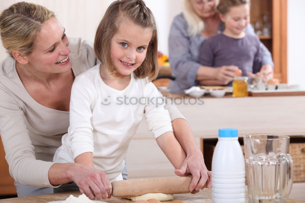 Similar – Image, Stock Photo Little sisters cooking with her mother in the kitchen.