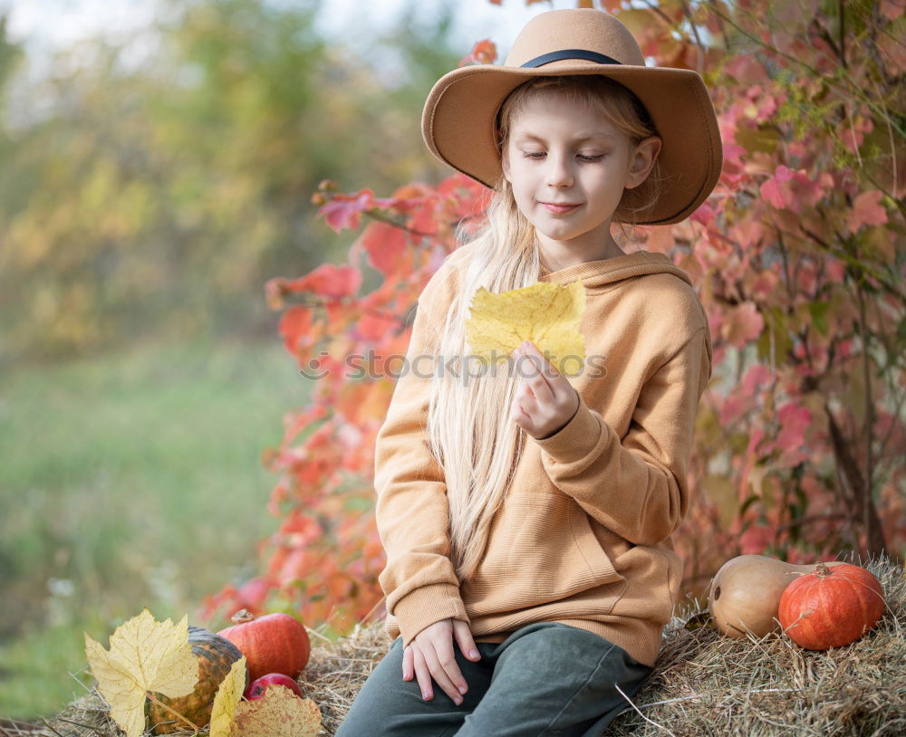 Similar – Cheerful kid in costume posing on tree