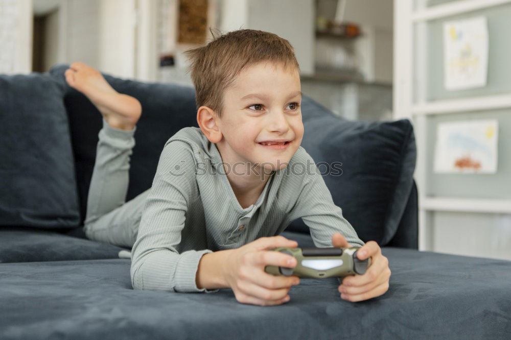 Similar – Toddler boy playing with new toy wearing pyjamas