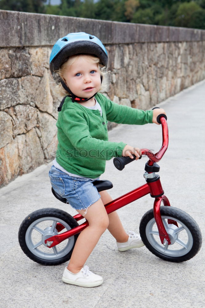 Similar – Image, Stock Photo Little kid riding his bike down the street