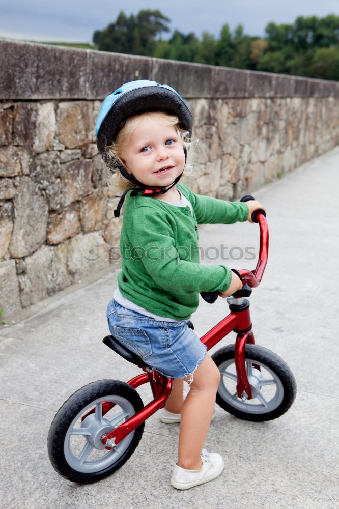 Image, Stock Photo Little kid riding his bike down the street