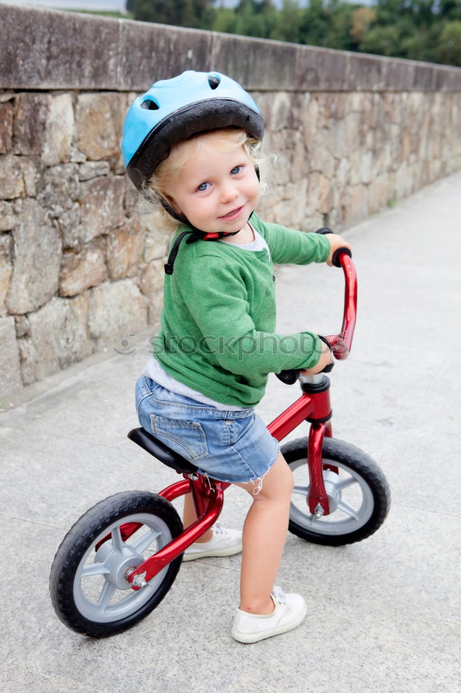 Similar – Image, Stock Photo Little kid riding his bike down the street