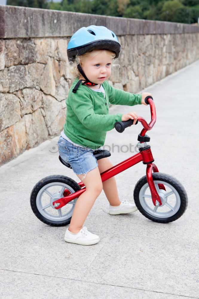 Similar – Image, Stock Photo Litle boy with a bike on a wooden door background