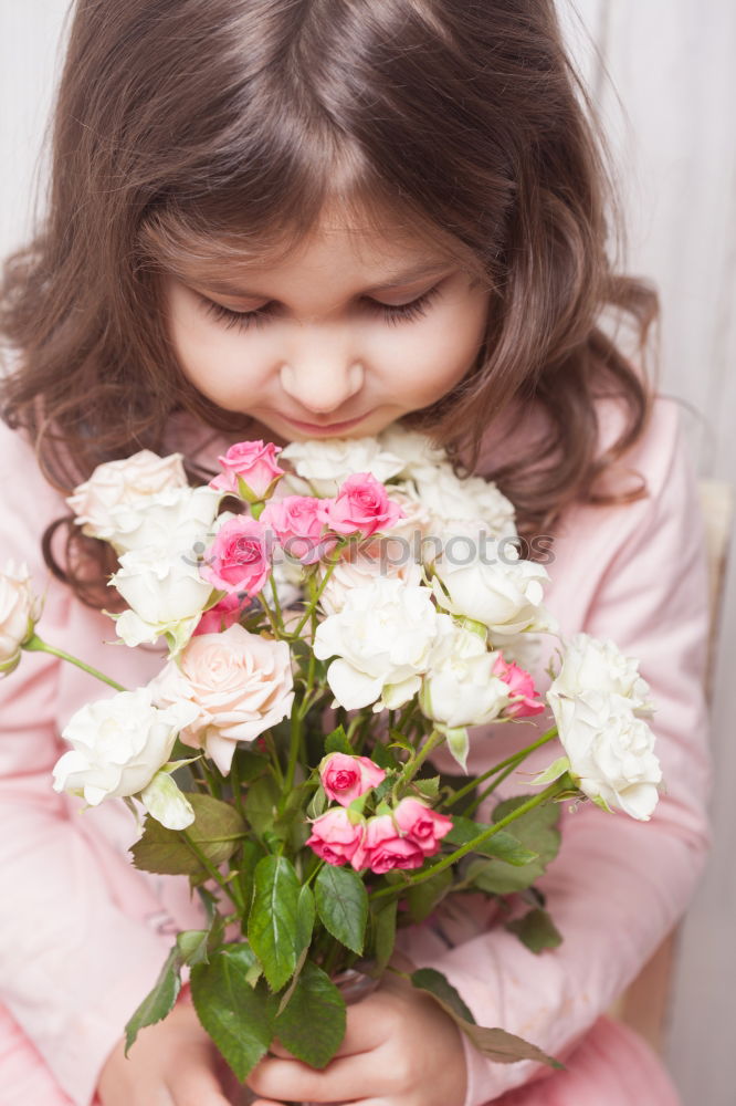 little girl observing flowers