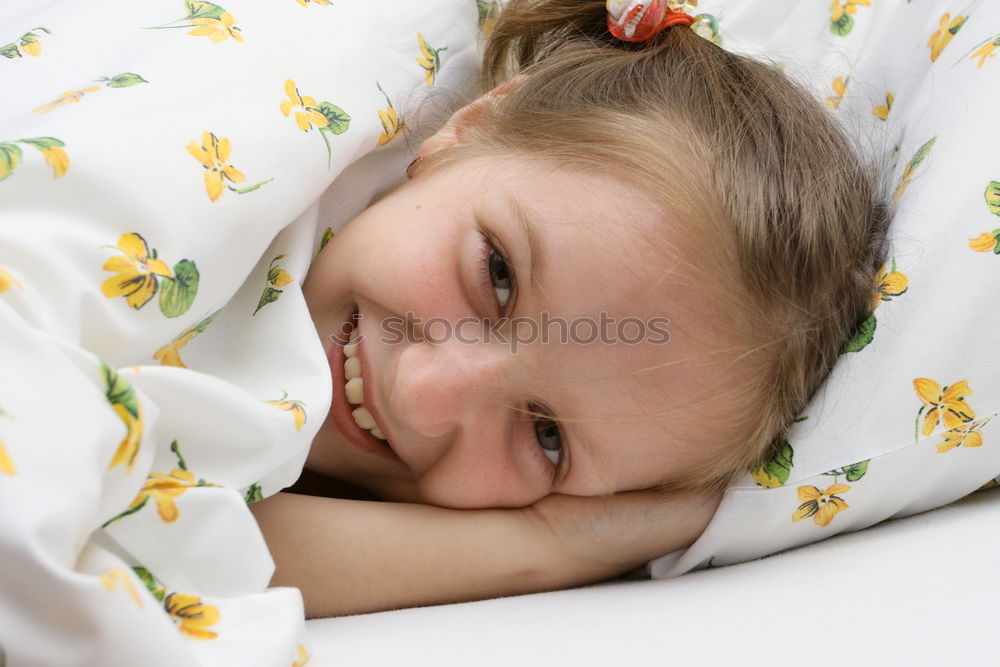 Similar – Little girl lying in a bed with teddy bear at the morning