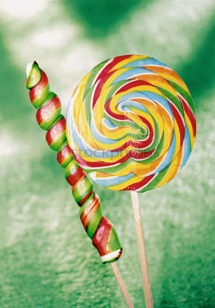 Similar – Image, Stock Photo Nice lollipop with many colors in a spiral on a blue background