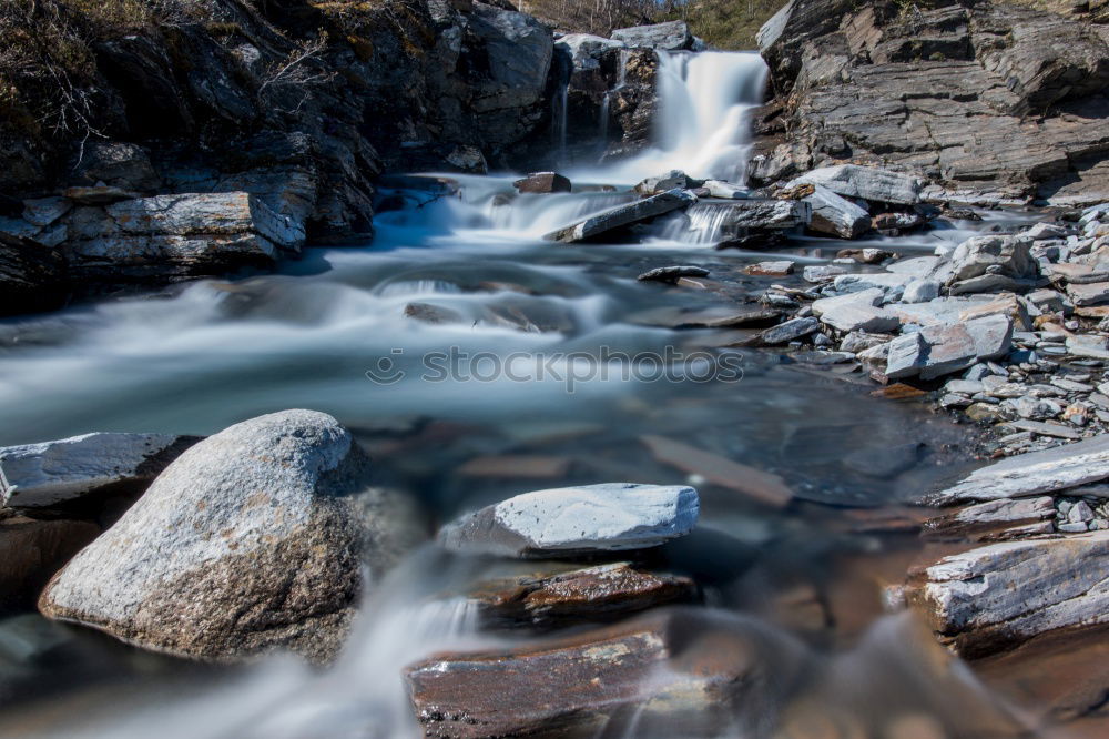 Similar – Image, Stock Photo A wild river flowing through large rocks with moss