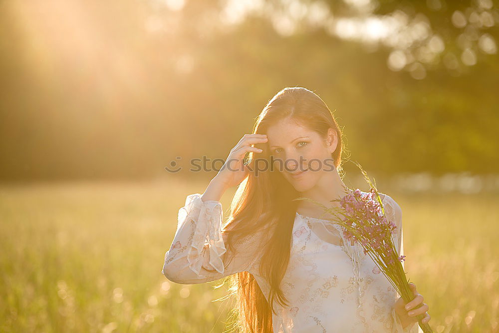 Similar – Image, Stock Photo Thoughtful young woman with bowed head on yellow meadow. Attractive girl with bowed head on a meadow of flowers in yellow to the horizon in the sunshine in spring or summer. Photo of a series.