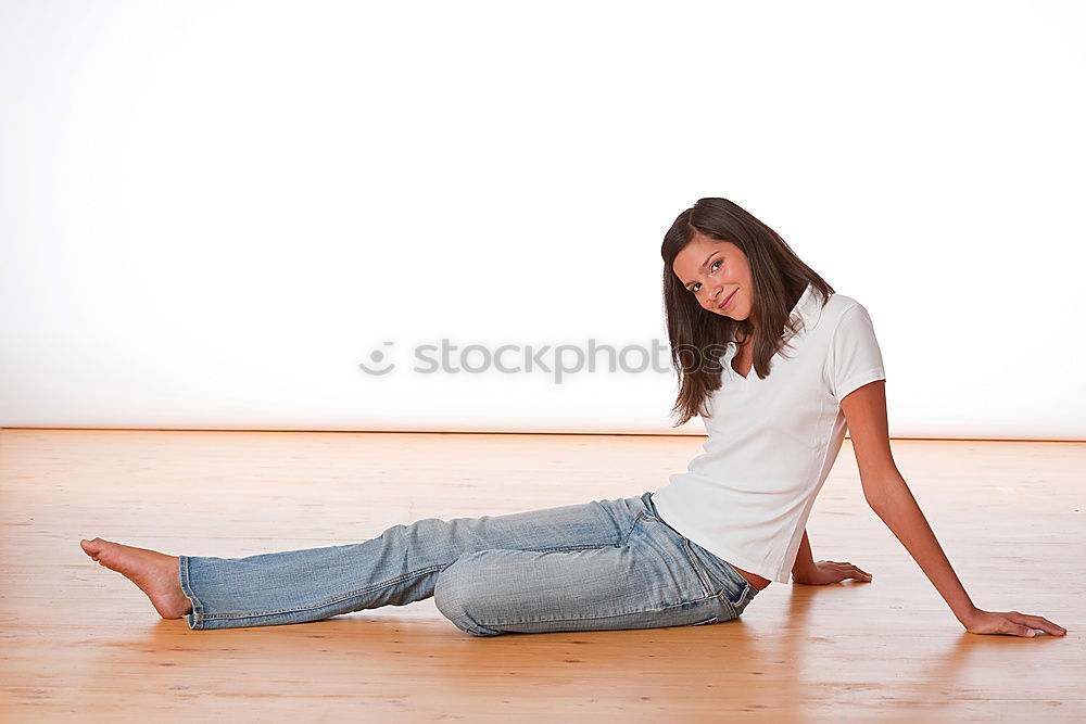 Similar – Image, Stock Photo Young, athletic, slender woman stands sideways in front of a white wall with her head bent forward so that her long brunette hair hangs down in front of her face