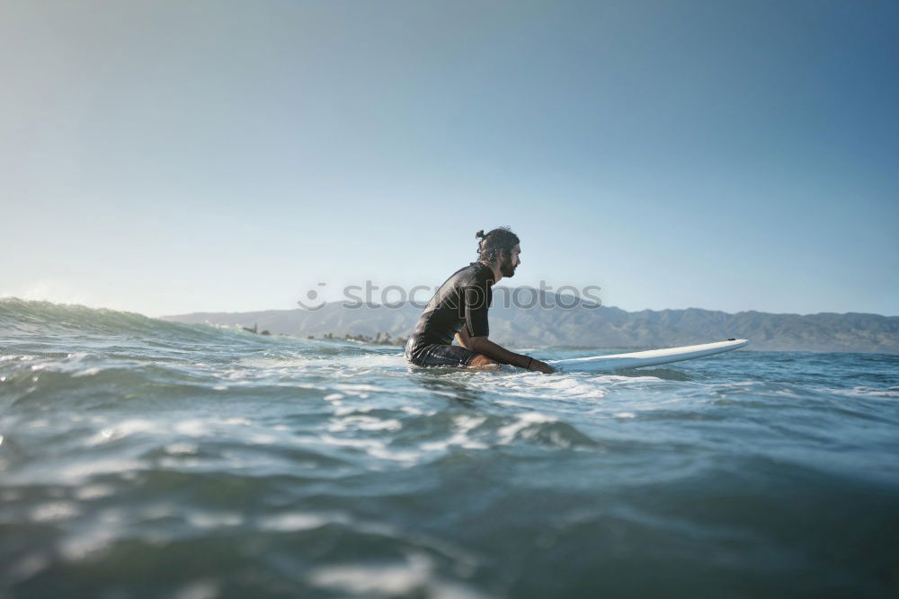 Man in wetsuit swimming in ocean