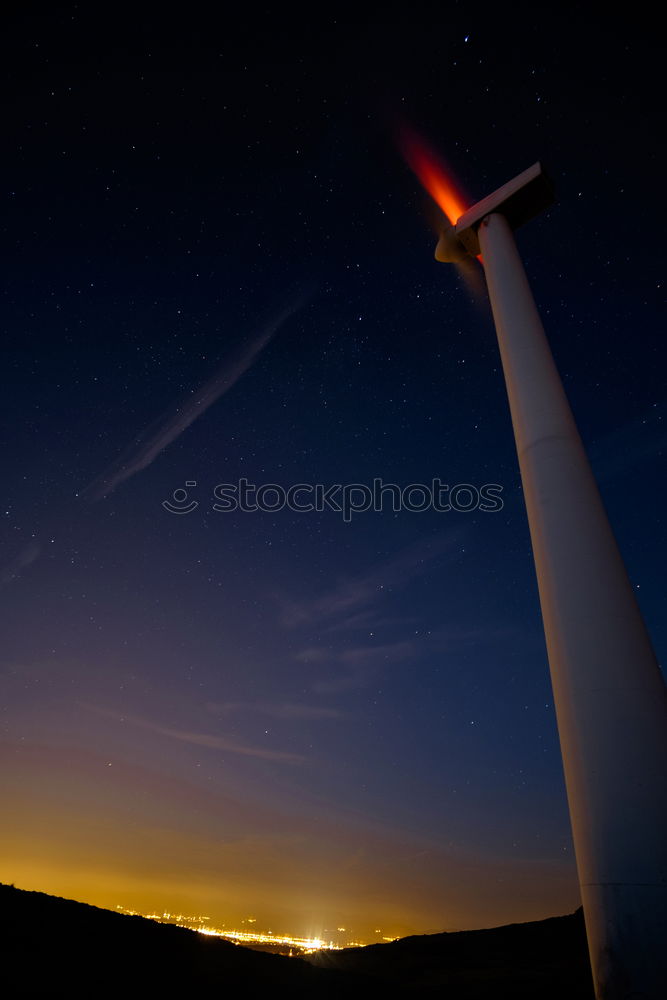 Similar – Rape blossom in the moonlight. Under the starry sky, windmills stand in blooming rapeseed fields.the air is filled with heavy fragrance.