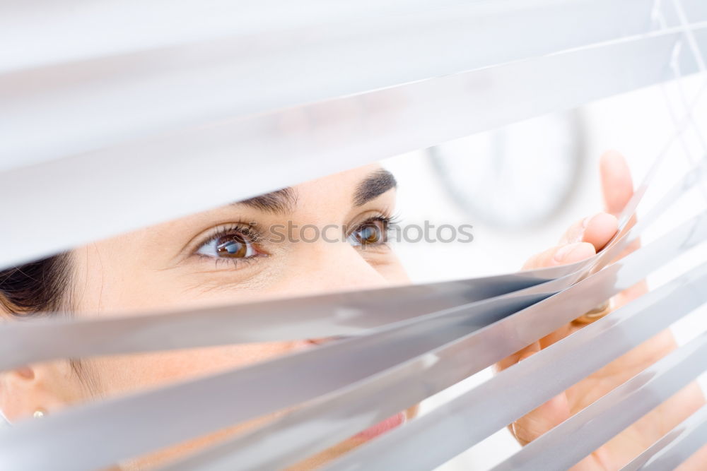 Similar – Woman looks sceptically around the corner