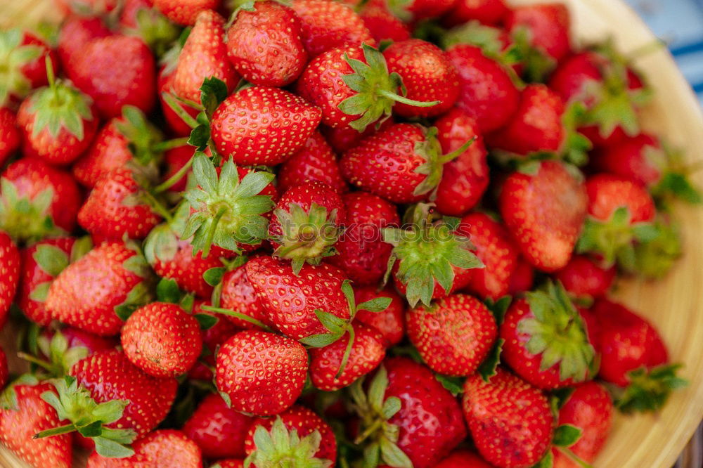 Similar – red strawberries with green stems in sale trays