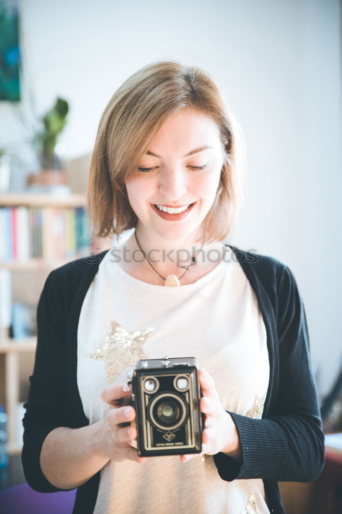 Similar – Cropped woman with vintage old camera