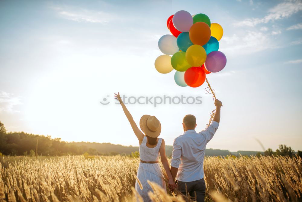 Similar – Father and daughter with balloons playing on the beach at the day time. Concept of friendly family.