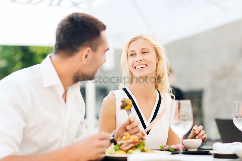 Similar – Cute young adult couple taking photo at outdoor picnic