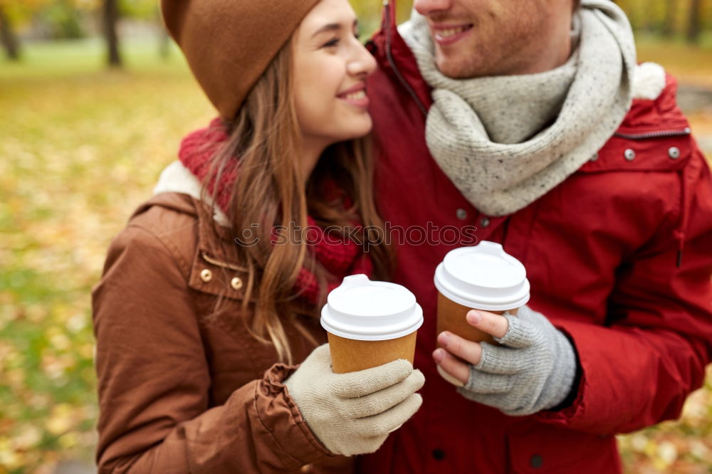 Similar – Young couple under blanket having hot drink in a cold day