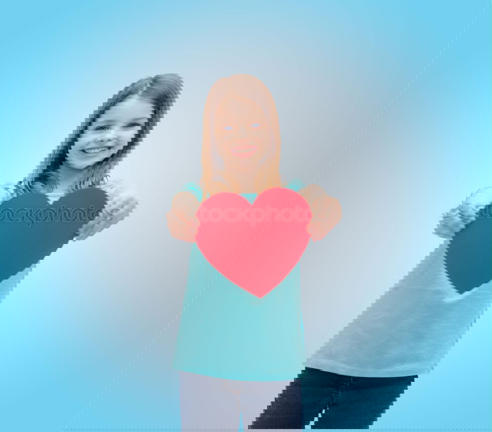 Image, Stock Photo smiling girl with a heart covering her lips on blue background