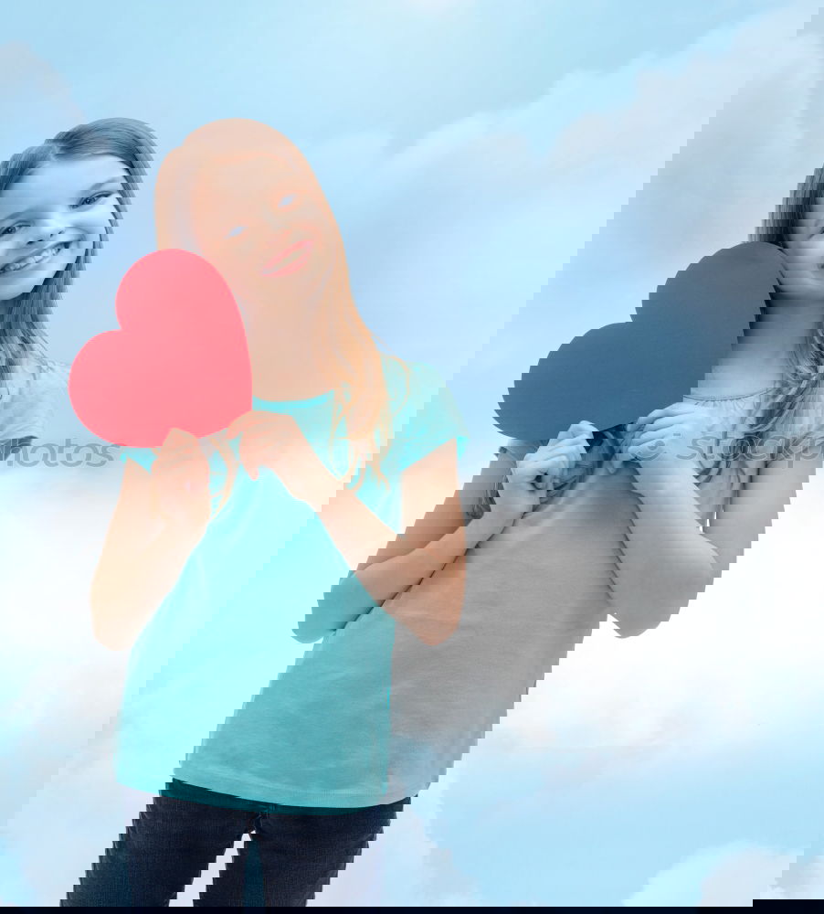 Similar – Image, Stock Photo smiling girl with a heart covering her lips on blue background