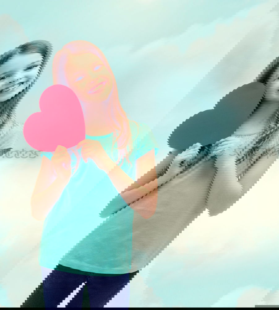 Similar – Image, Stock Photo smiling girl with a heart covering her lips on blue background