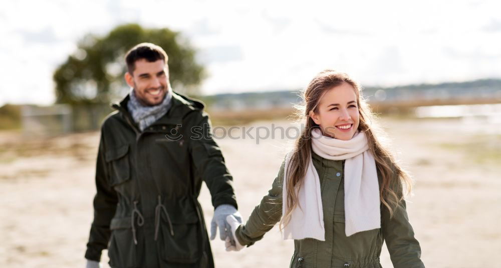 Similar – Young couple embracing and having hot beverage outdoors