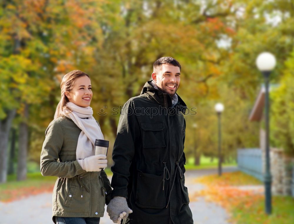 Similar – Young couple embracing and having hot beverage outdoors