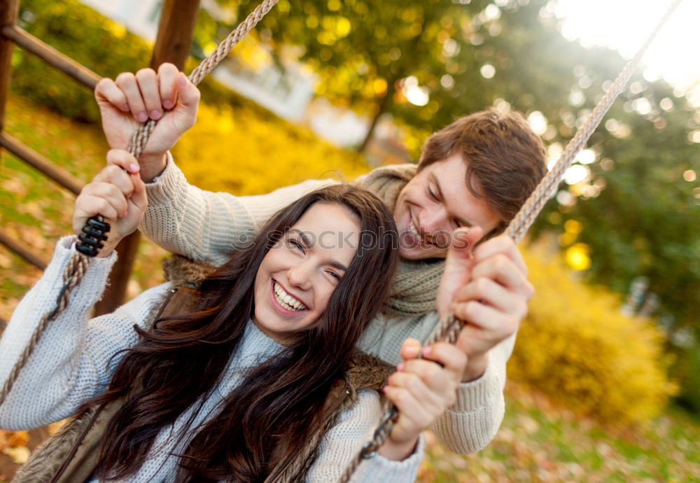 Similar – Young couple under blanket with hot drink kissing outdoors