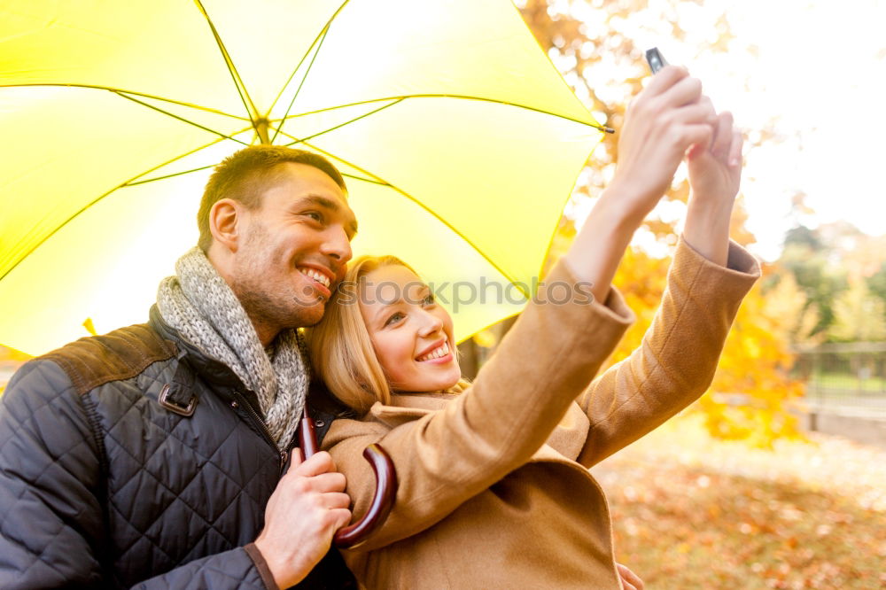 Similar – Young couple looking at each other under umbrella outdoors