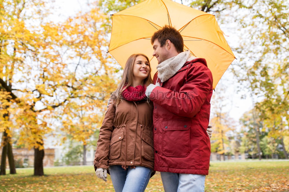 Similar – Young couple looking at each other under umbrella outdoors