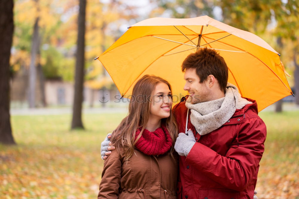 Similar – Young couple looking at each other under umbrella outdoors