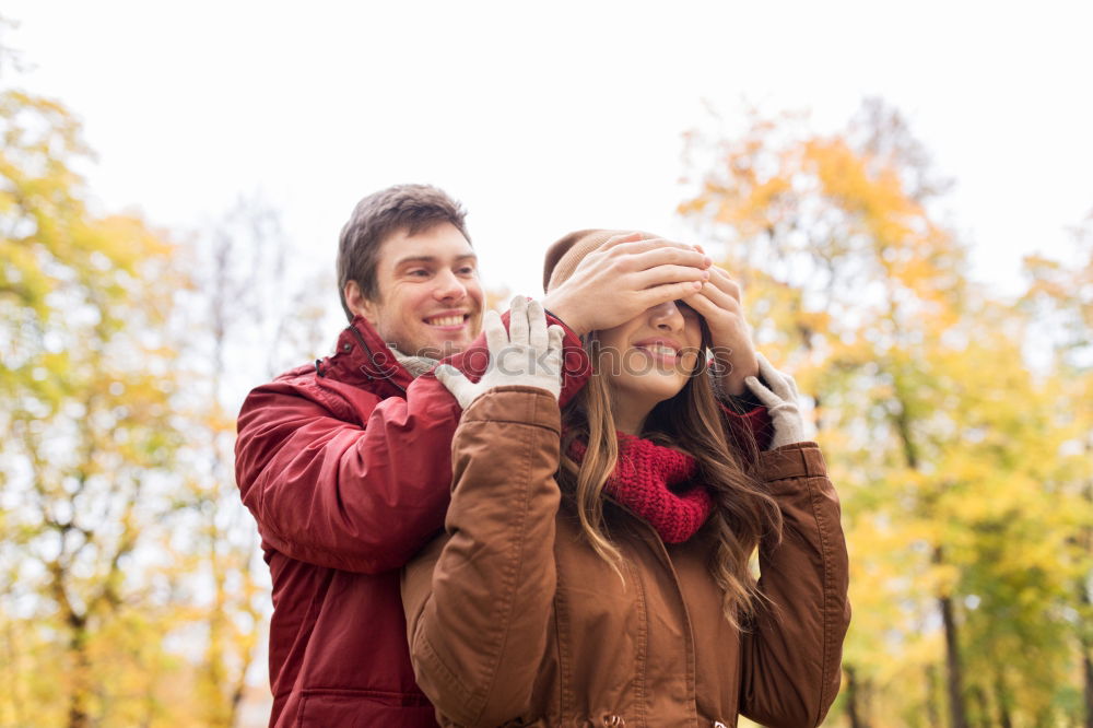 Similar – Young couple under blanket having hot drink in a cold day