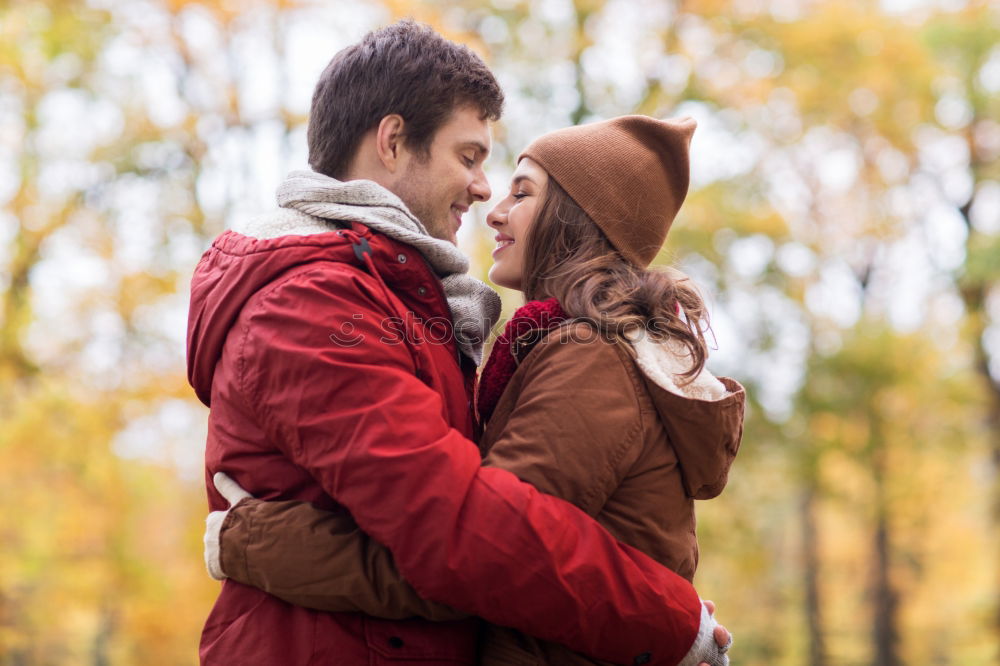 Similar – Young couple embracing and having hot beverage outdoors