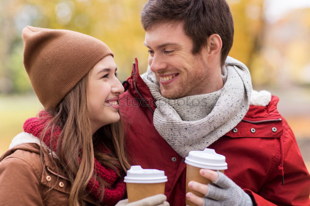 Similar – Young couple under blanket having hot drink in a cold day