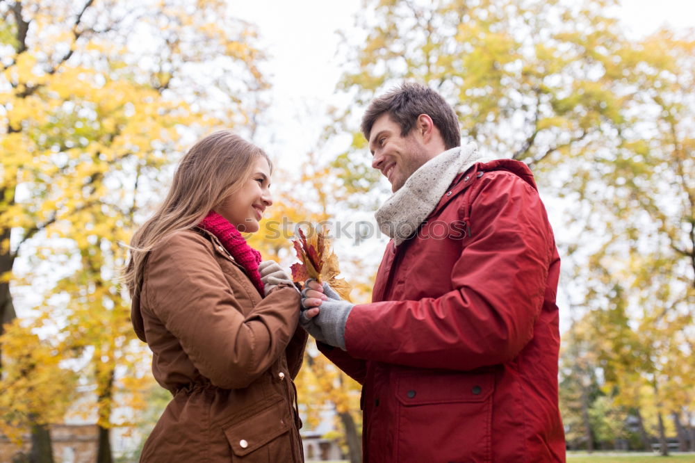 Similar – Young couple under blanket having hot drink in a cold day